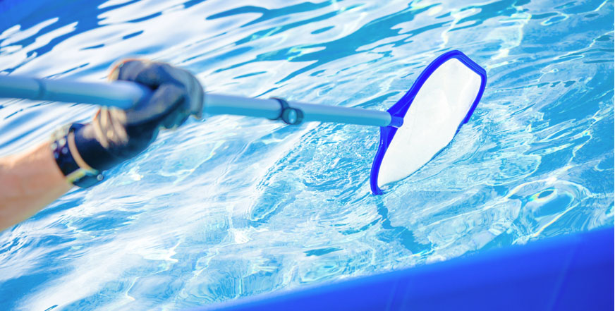 pool cleaning technician using skimmer